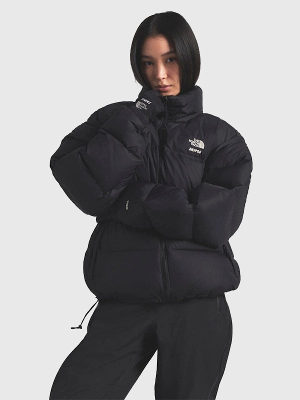 Recreated The North Face × SKIMS 1996 Nuptse parachute puffer jacket in black with insulated warmth and streamlined silhouette.