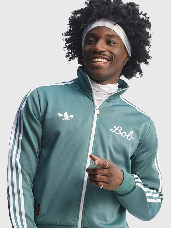 Green Adidas x Bob Marley 2026 Football Is Freedom track jacket recreated with bold graphic elements and unisex athletic tailoring.