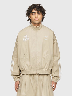 Recreated chino beige Adidas x Willy Chavarria track jacket with Compton Cowboys embroidery and structured stand collar