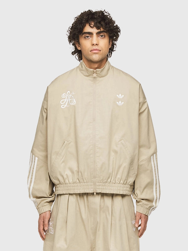 Recreated chino beige Adidas x Willy Chavarria track jacket with Compton Cowboys embroidery and structured stand collar