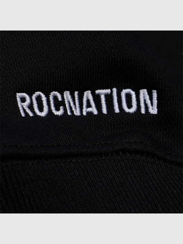 Black Roc Nation x Paper Planes Super Bowl LX 2026 fleece pullover hoodie recreated with relaxed fit and streetwear–centered graphic design.