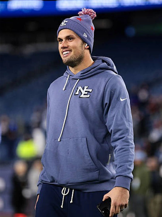 Patriots 2025 Rivalries pullover hoodie in storm blue modeled after Drake Maye’s sideline gear.