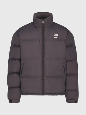 Recreated 1996 Nuptse brown parachute puffer jacket from The North Face × SKIMS with soft, weather-ready insulation.