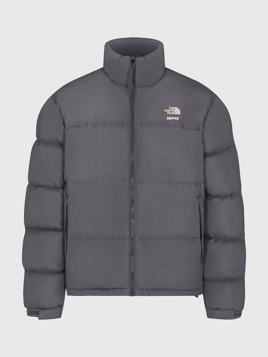 The North Face × SKIMS grey Nuptse parachute puffer jacket recreated with soft insulated layers and structured silhouette.